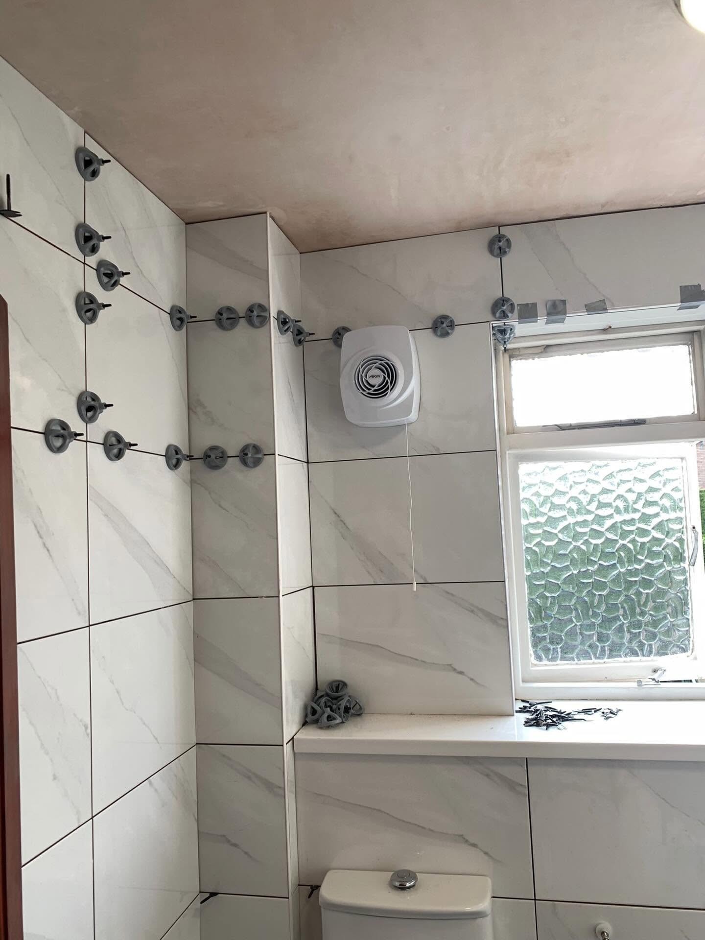 Newly tiled bathroom with an extractor fan fitted