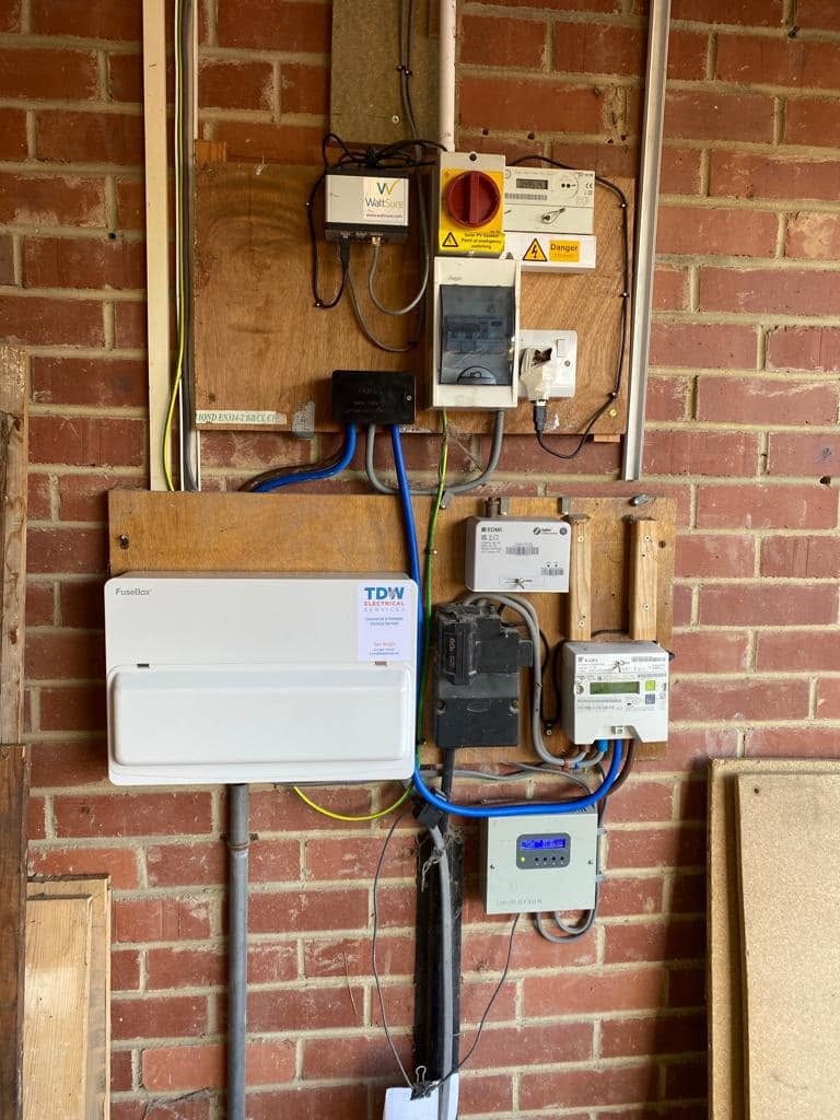Neat new consumer unit and meter board on a brick wall