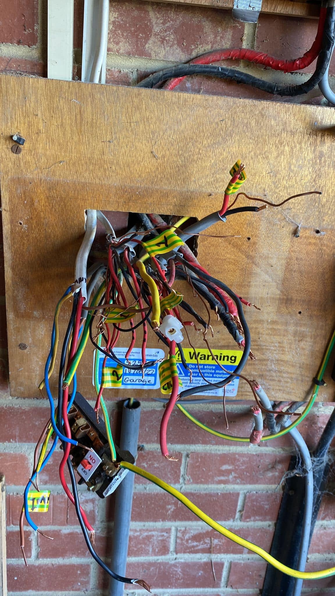 Old tangled wiring on a plywood board