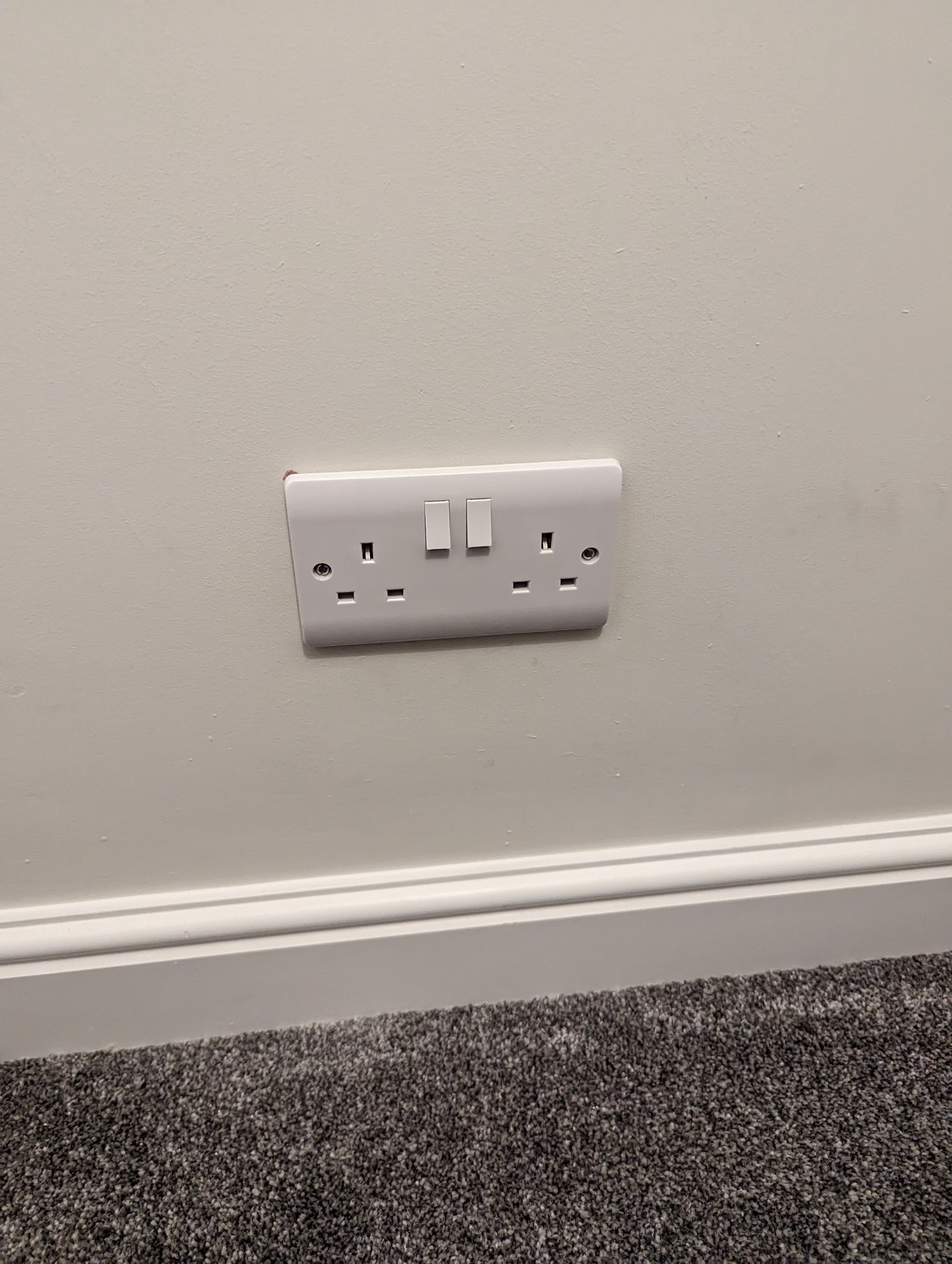New white double socket above the skirting board