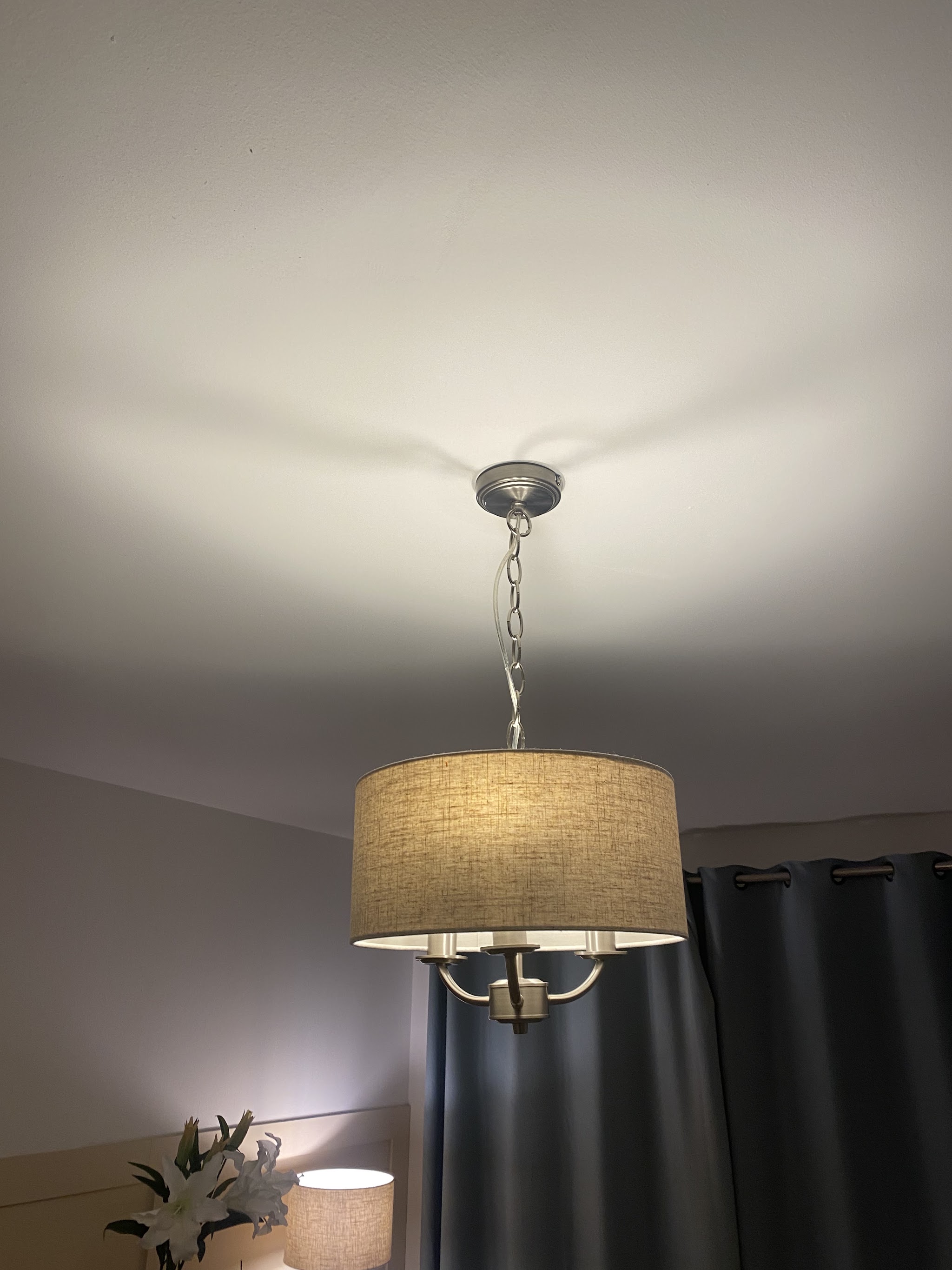 Fabric drum pendant light hanging in a lounge